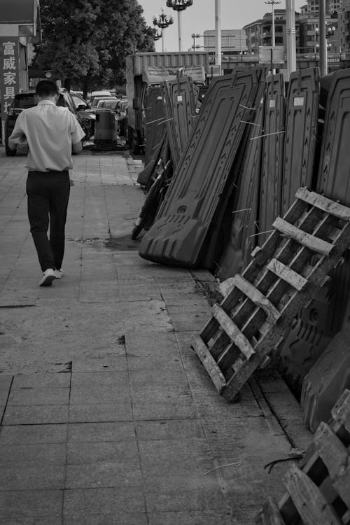 Backview of Man walking near Scraps 