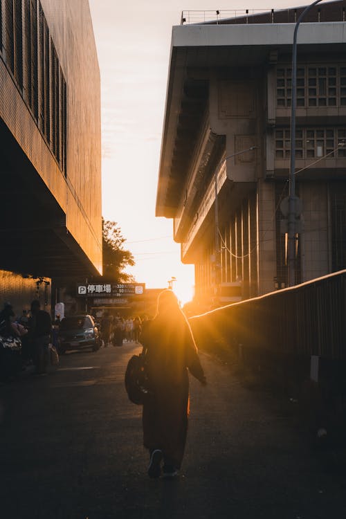 Backview of Person walking near Buildings 