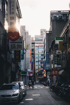 A vibrant city alley lined with shops, signages, and pedestrians capturing urban life.