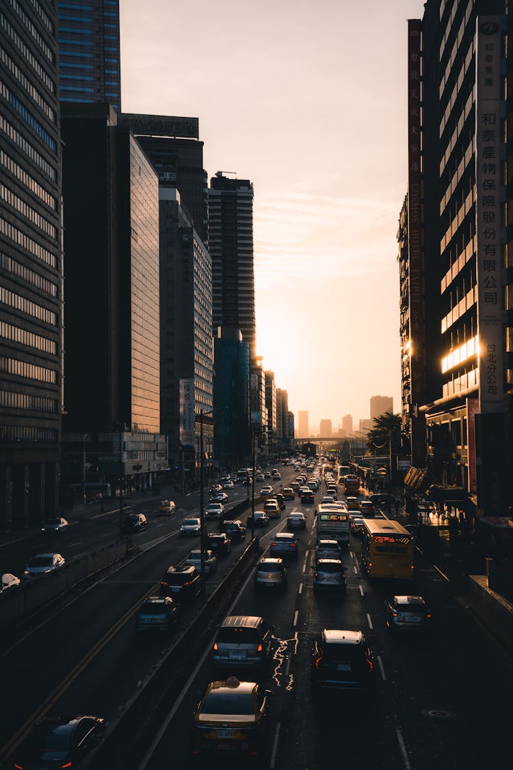 An Aerial Shot Of A Cars Travelling On A Road In A City