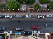 Aerial view of parked cars along a street in Port Said, Egypt, showcasing urban life.