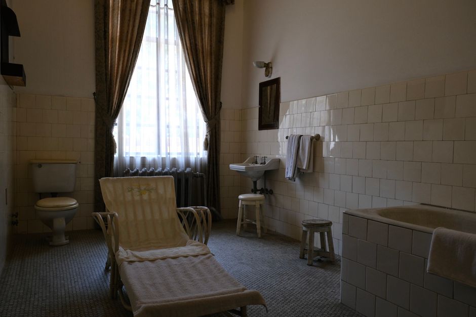 A vintage bathroom featuring classic tiles and antique fixtures, creating an outdated charm.