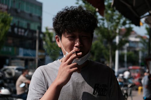 Free Close Up Photo of a Man Smoking Cigarette Stock Photo