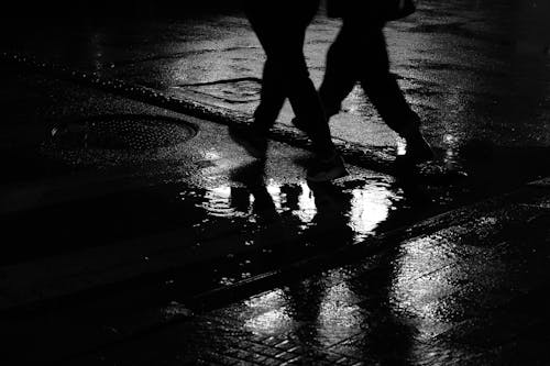 Silhouette of Two People walking on Road 