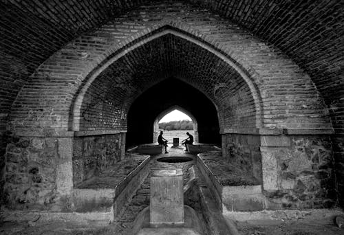 Monochrome Photo of an Arched Tunnel 