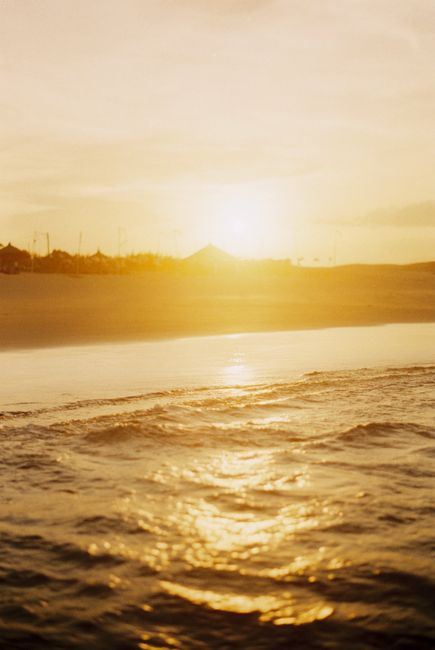 Peaceful seaside scene capturing gentle waves and golden sunset hues, evoking tranquility and serenity.