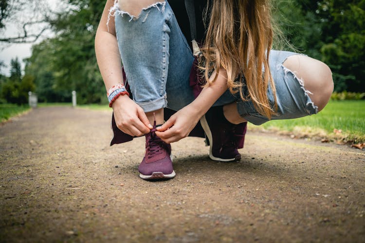 Woman Tying Her Shoes