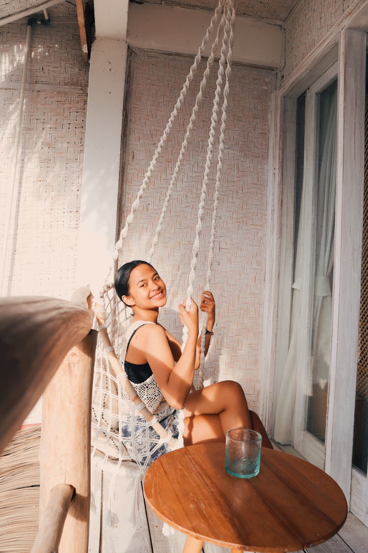 Beautiful Young Woman On A Swing 