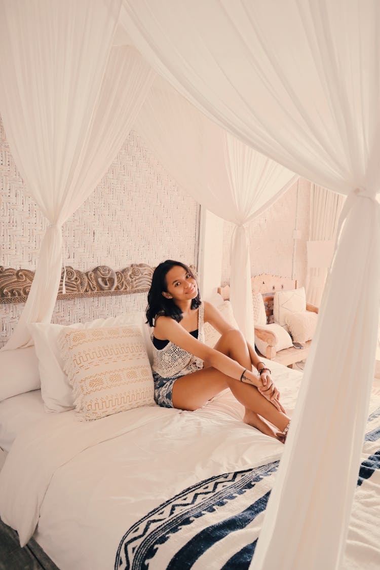 Beautiful Young Woman On A Bed 