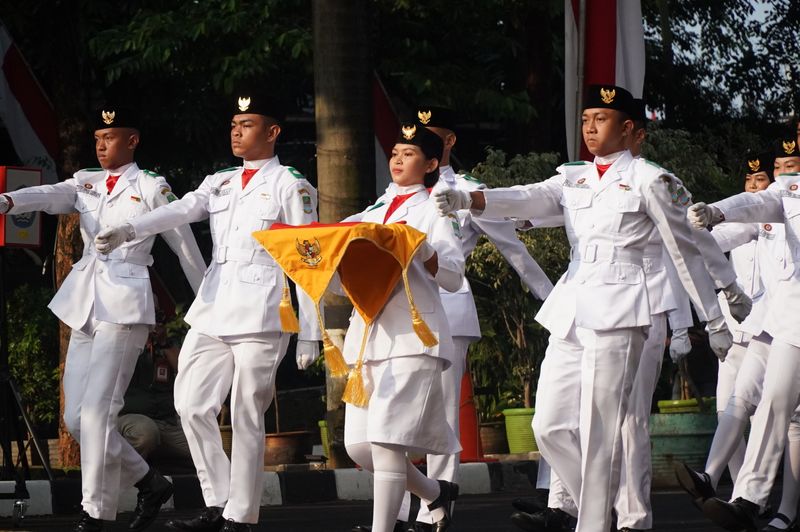 Students in ceremonial uniforms march during Independence Day