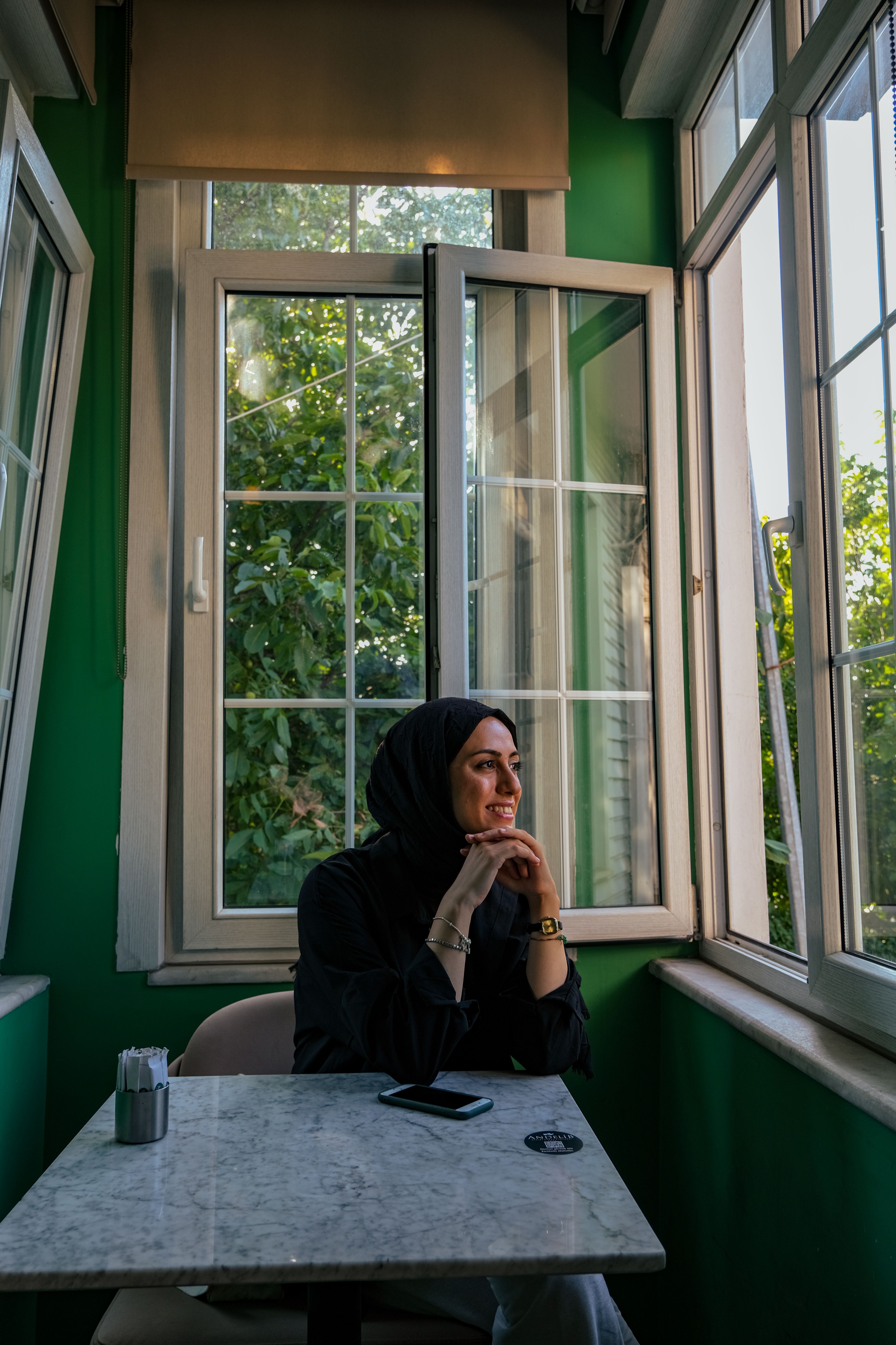 A Woman in Hijab Sitting at the Table · Free Stock Photo