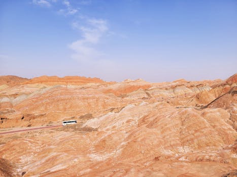 A breathtaking view of colorful rock formations in a desert landscape under a clear blue sky.