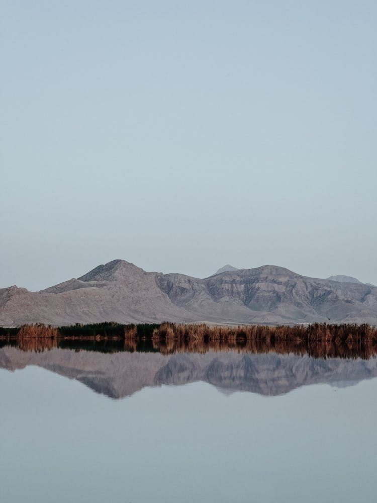 A Reflection Of The Mountains On A Lake