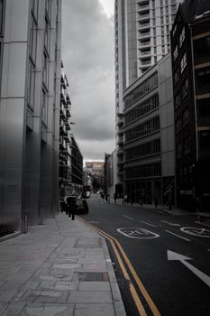 City street with high-rise buildings and cars, showcasing urban architecture.