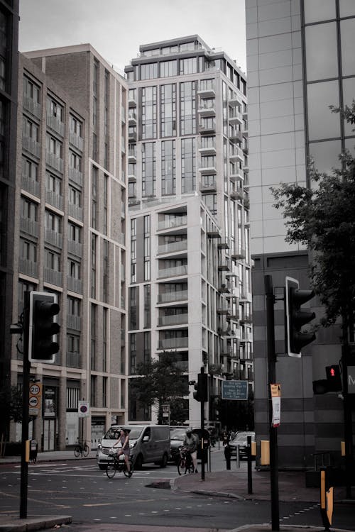 Cars on Road in Between High-rise Buildings