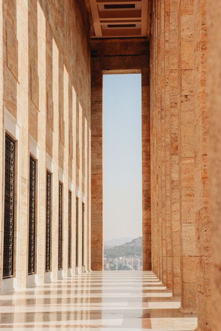 Elegant marble hallway with sunlight streaming through columns at Anıtkabir, Ankara.