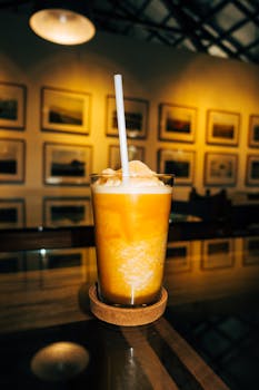 Delicious orange smoothie in a stylish cafe, perfect for a refreshing treat.