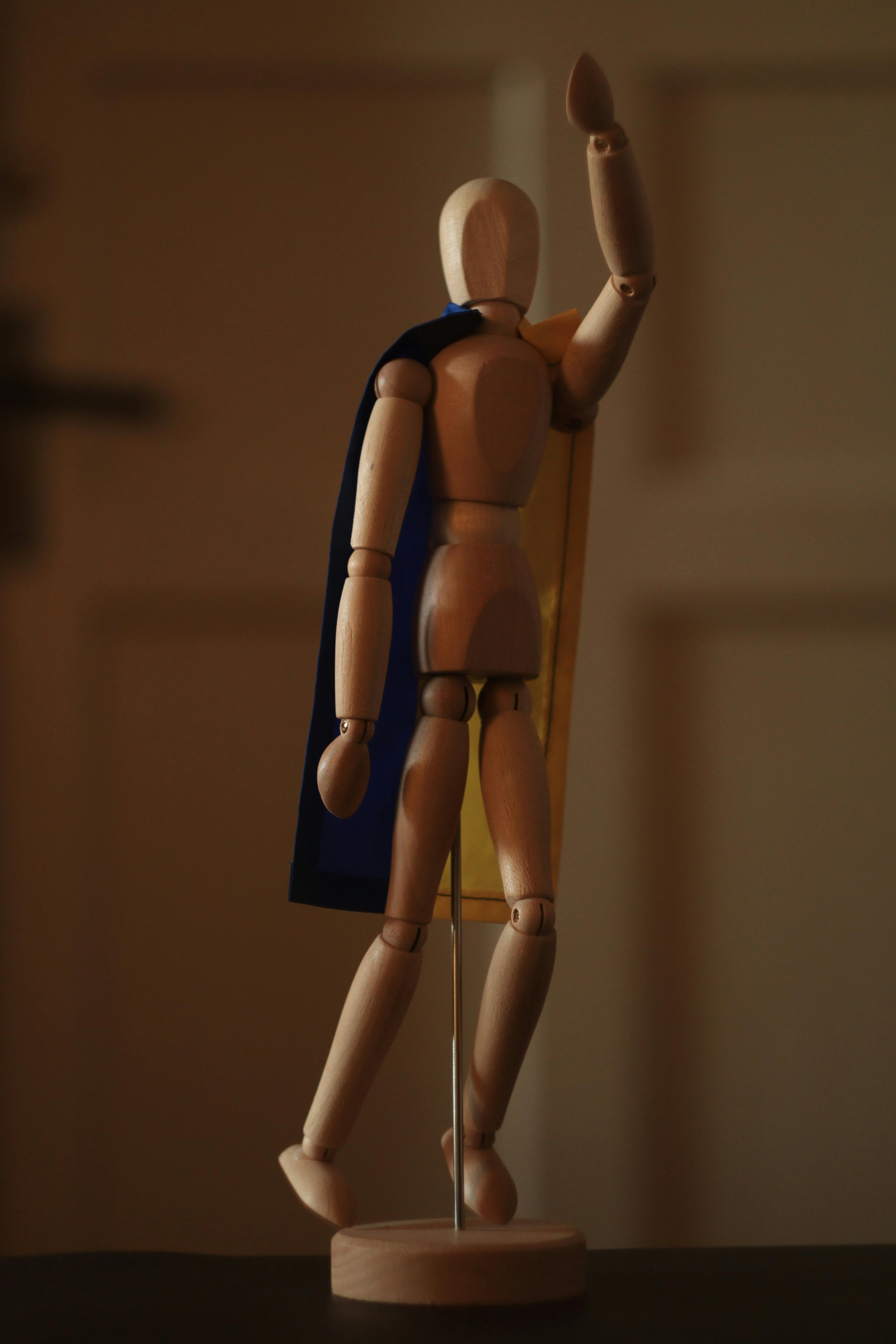 An artist's mannequin with a contemplative pose symbolizes creativity  against a wooden backdrop. from Pikwizard