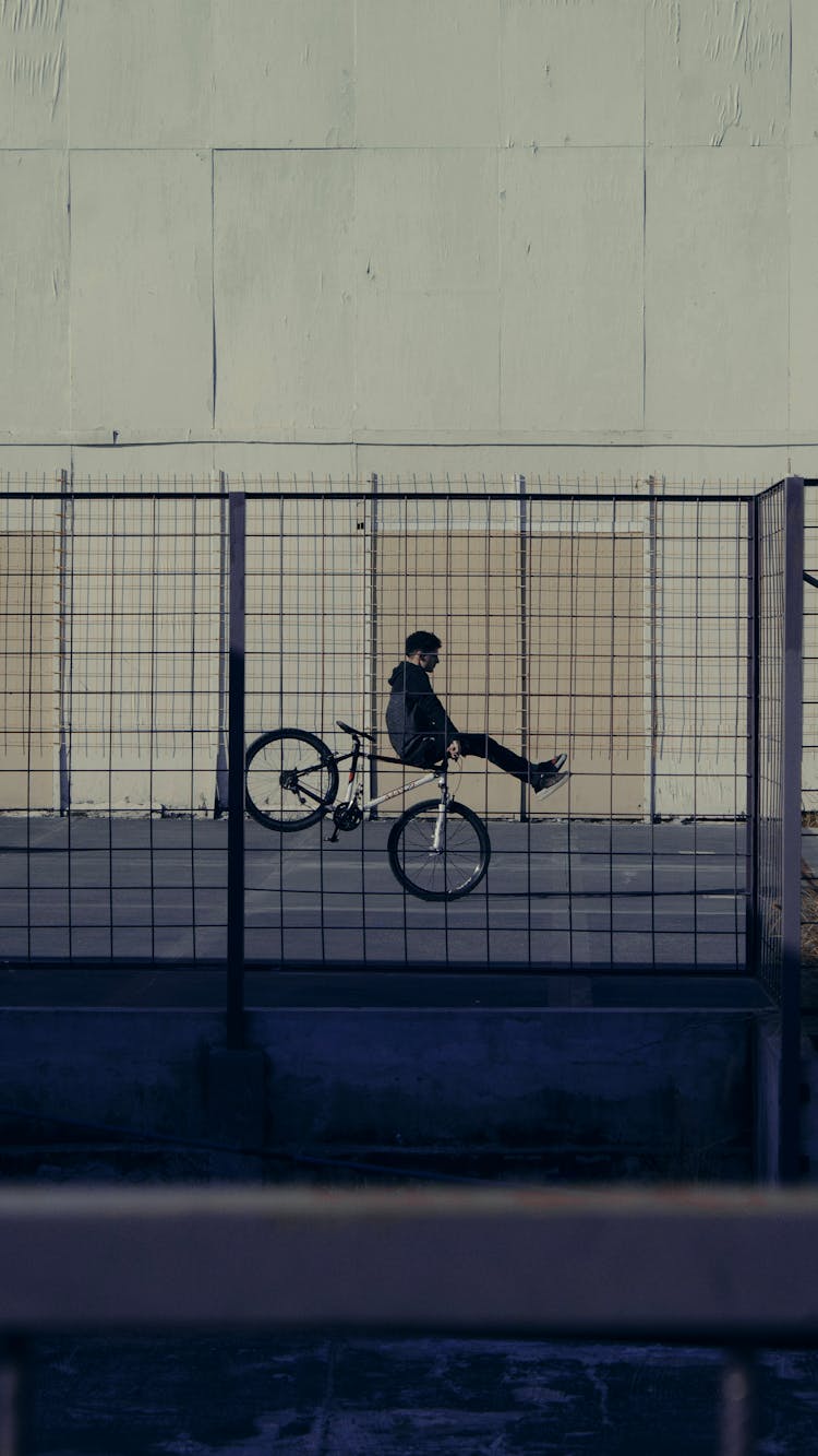 A Man Doing Tricks With His Bike