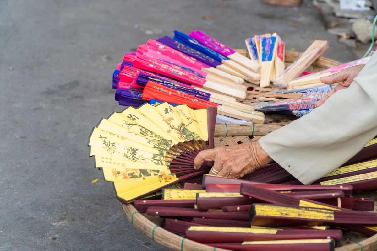 Handmade fans for sale at a stall