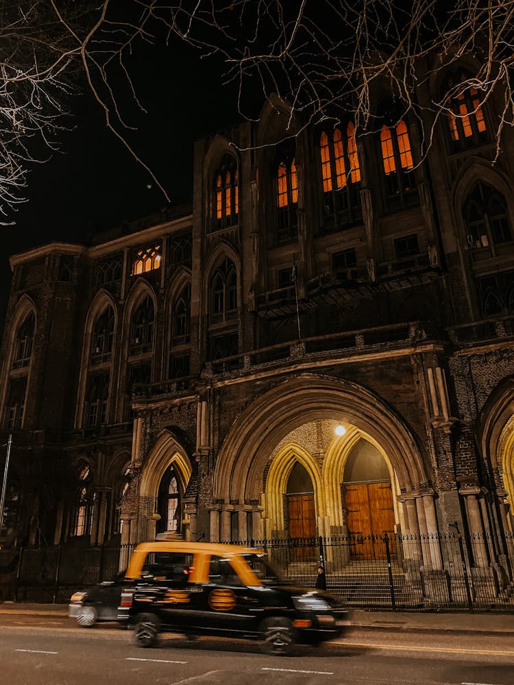 Taxi Near Building At Night