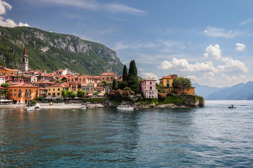 Free Picturesque view of Varenna, Italy with colorful houses along Lake Como's coast. Stock Photo