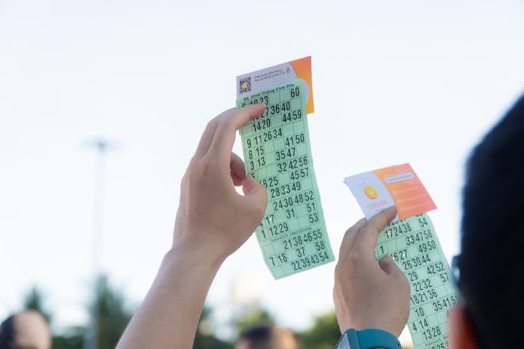 People Holding Tickets