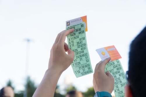 Free Close-up of hands holding transportation tickets, showcasing numbers and fare details. Stock Photo