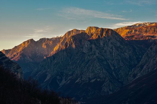 Stunning view of sunlit mountains in Bosnia, showcasing nature's beauty during sunset.