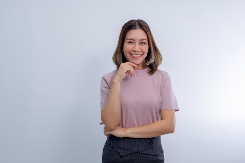 Free Smiling Woman Posing with Hand on Chin Stock Photo