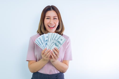 Free Woman in Pink Blouse Holding Cash Stock Photo