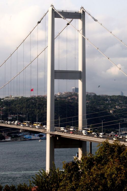 Free A view of the Bosphorus Bridge spanning over the waterway with a bustling city backdrop. Stock Photo