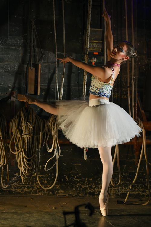 Free Ballerina gracefully posing backstage in Mar del Plata, Argentina with ropes and stage equipment. Stock Photo