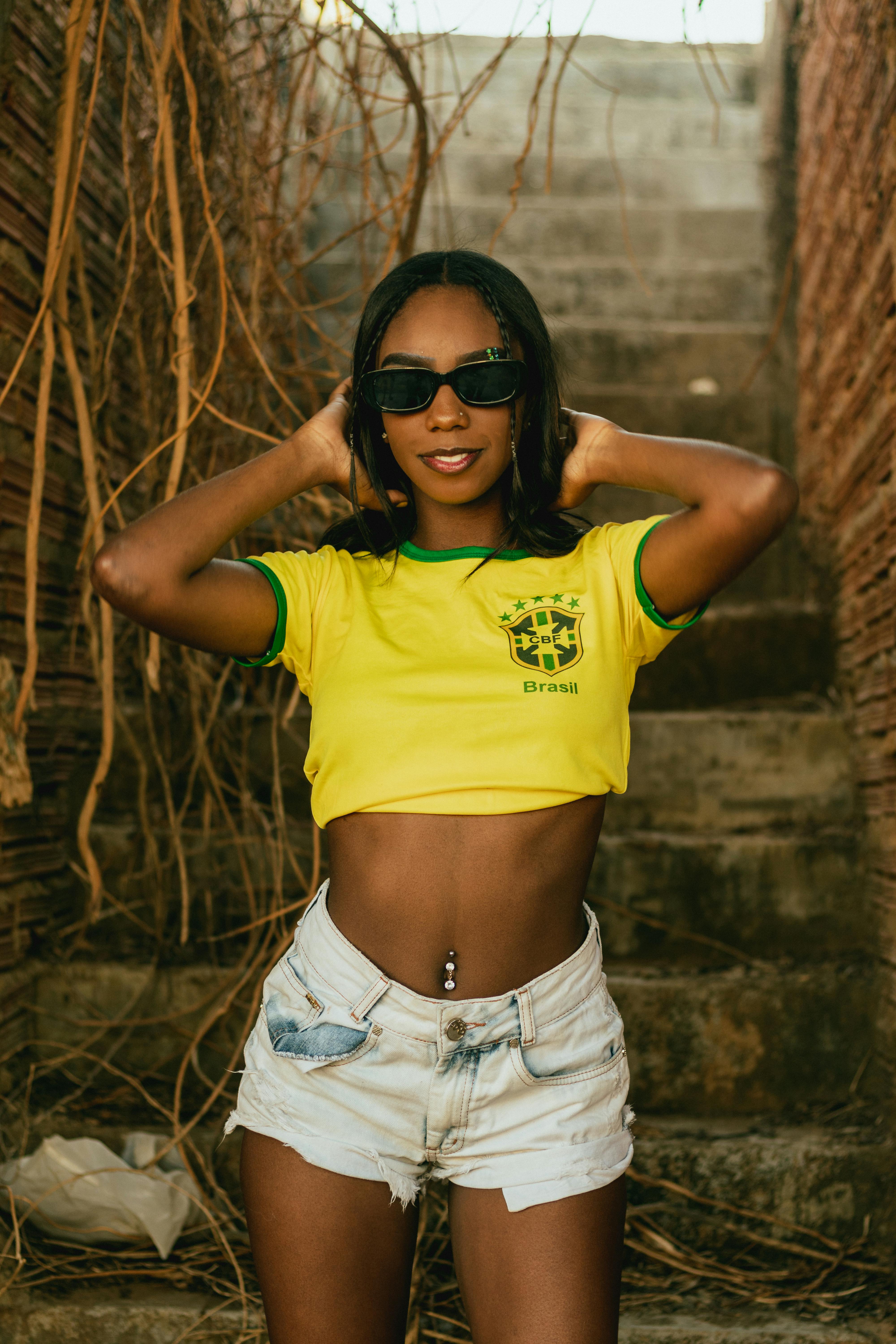 Woman in Yellow Brasil Crop Top Posing · Free Stock Photo