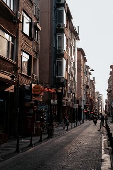 Late afternoon view of a quaint European street lined with diverse urban architecture.