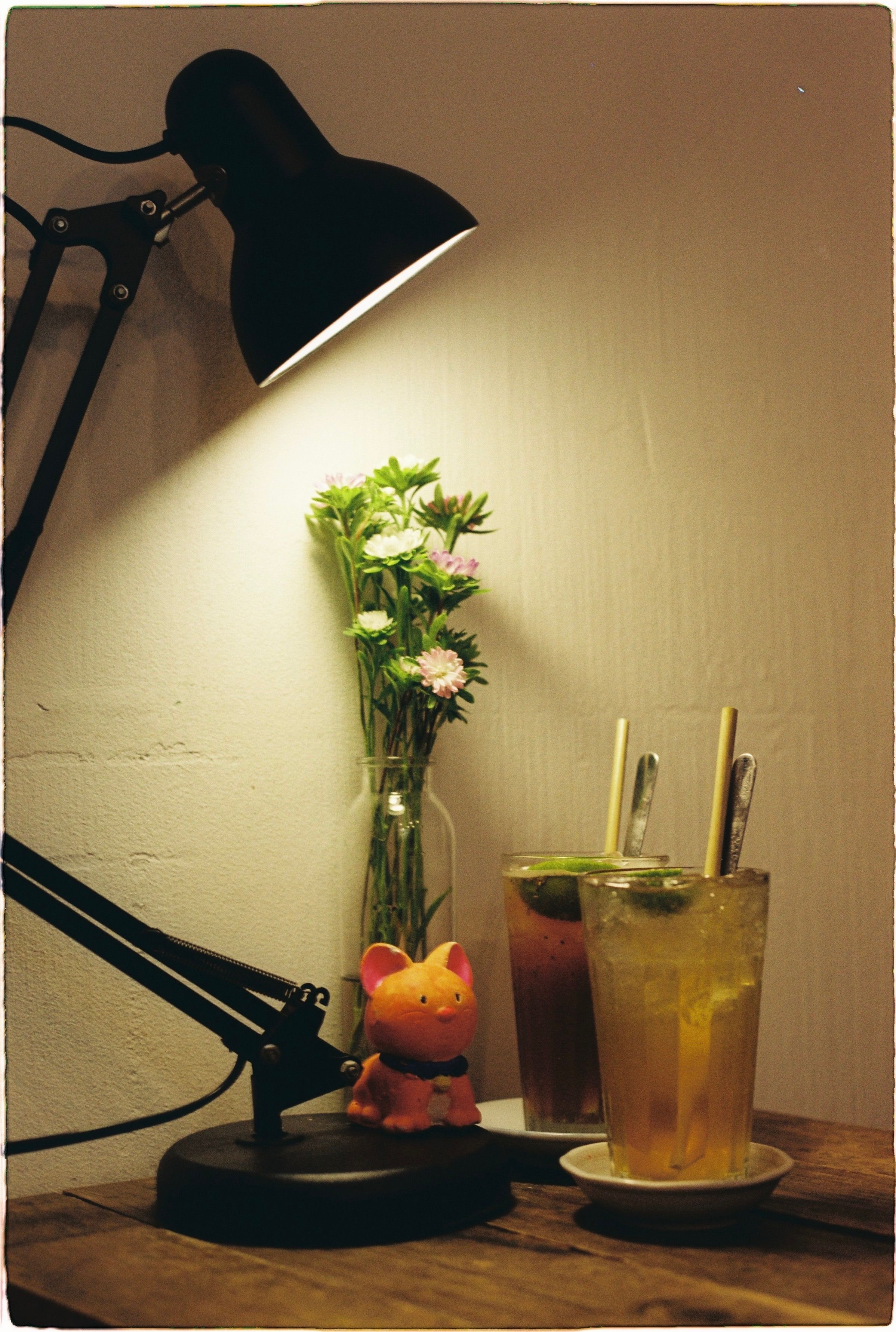 An inviting indoor scene with stylish lighting, fresh flowers, and chilled beverages for relaxation.