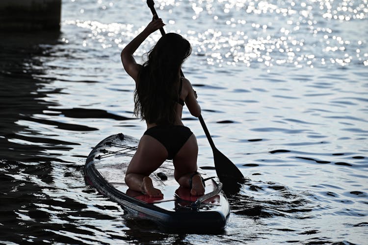 A Woman Paddleboarding 