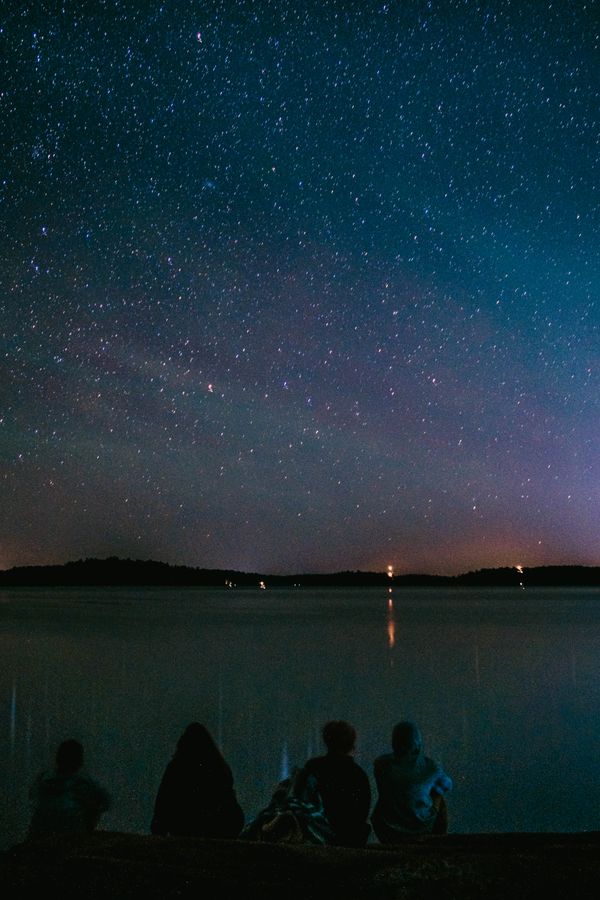 Friends together by the water at night