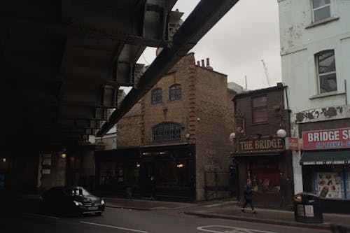 Car Passing under a Metal Bridge