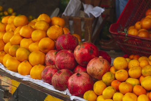 Pile of Mandarans and Pomegranate on a Market Stall 