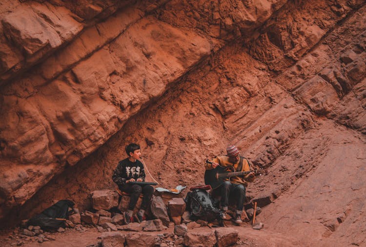 A Boy And Man Playing Music Instrument