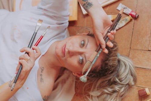 A Woman Holding Paintbrushes 