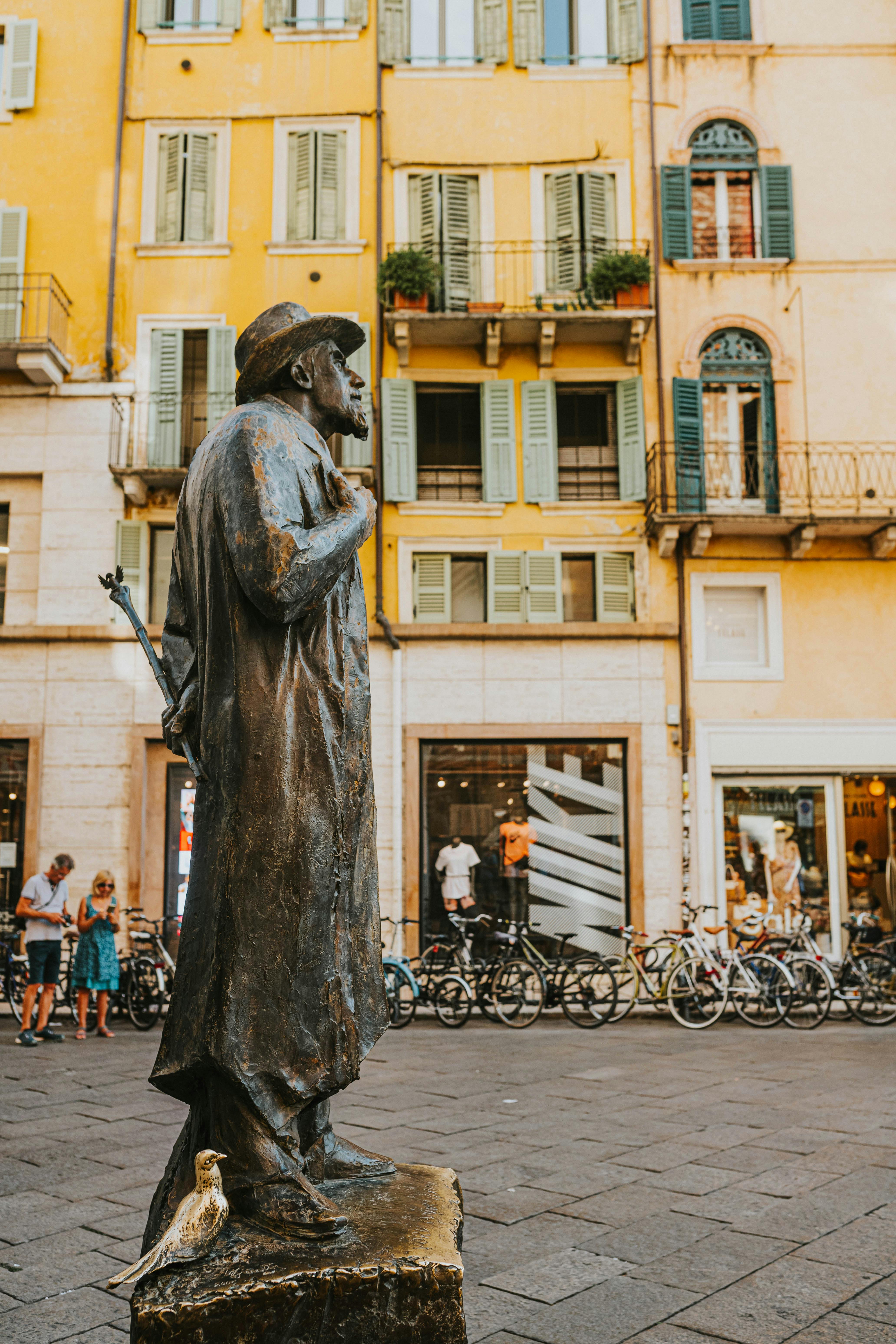 Statues Beside Apartment Building · Free Stock Photo