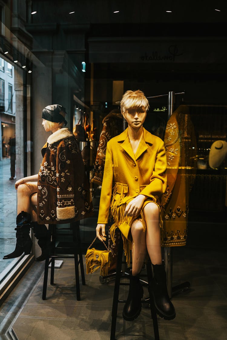 Mannequins Sitting By The Glass Window