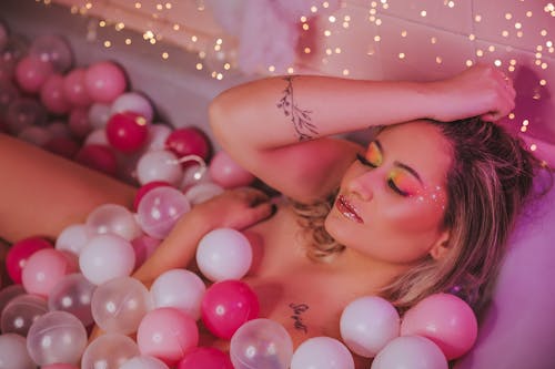 A Woman in the Bathtub with Balls while Eyes Closed