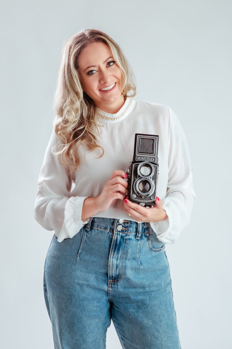 A Woman Holding A Vintage Camera