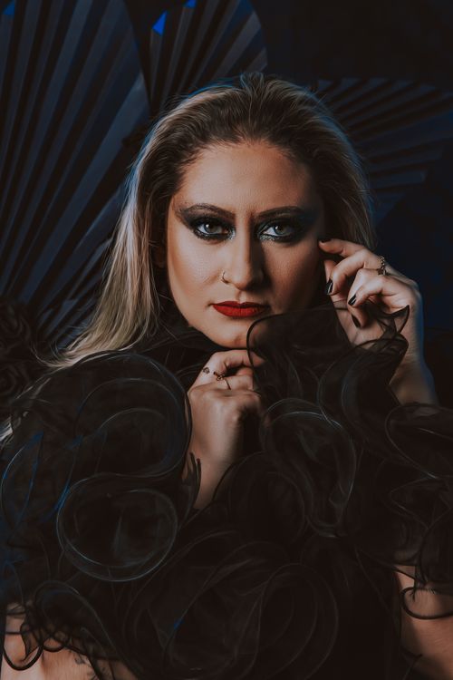 Free A striking portrait showcasing a woman with bold makeup and intricate black attire. Stock Photo
