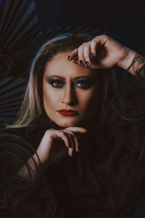 Free Striking portrait featuring a woman with bold makeup and captivating expression. Stock Photo