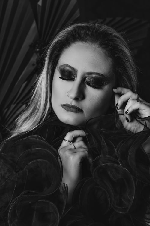 Free Moody black and white portrait of a woman with closed eyes and stylish fashion elements. Stock Photo