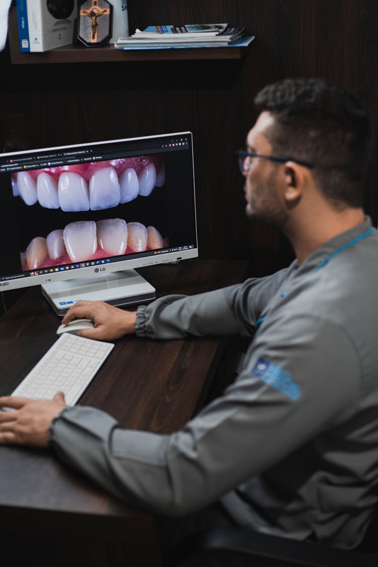 A Man Looking Teeth In The Monitor